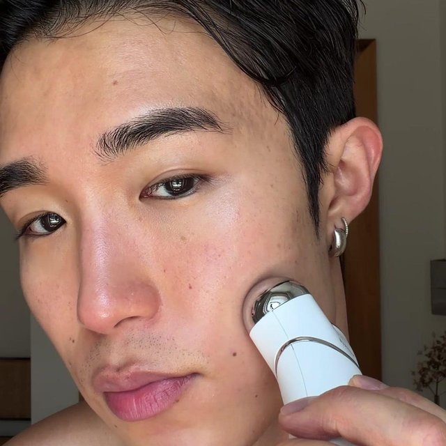 Close-up of microcurrent device tips on skin